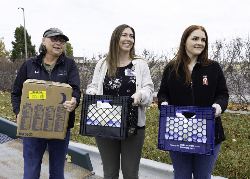   Community Health and Engagement team members carrying food. 