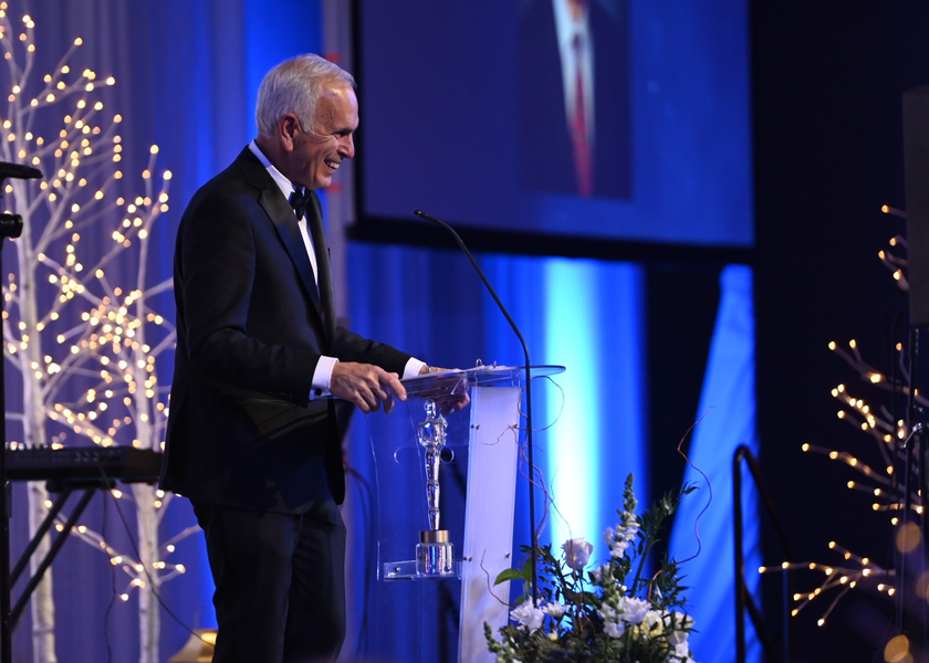 Rich Raimondi on stage receiving the 2025 Light of Philanthropy Award.