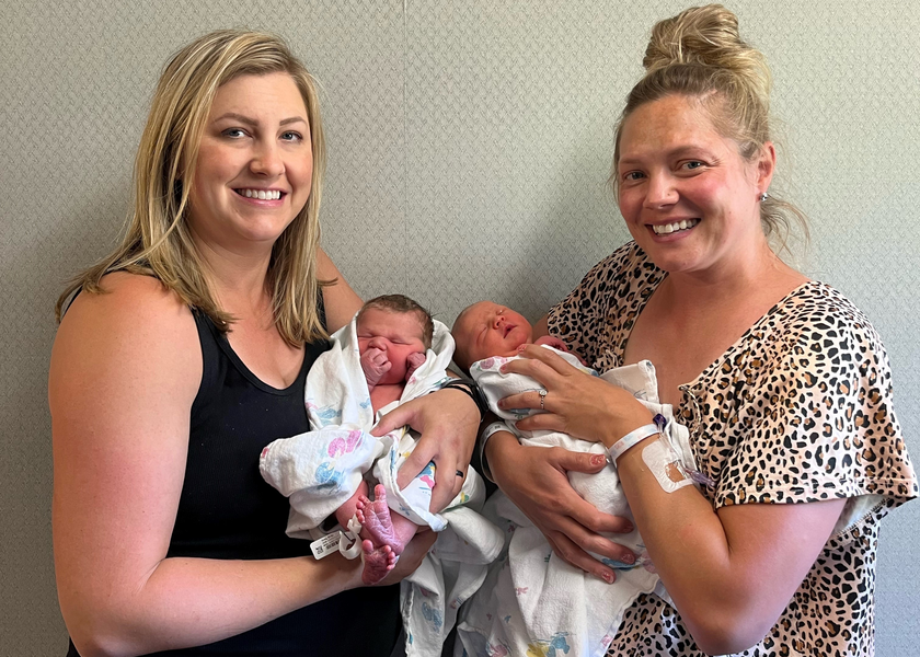Two women holding newborn babies