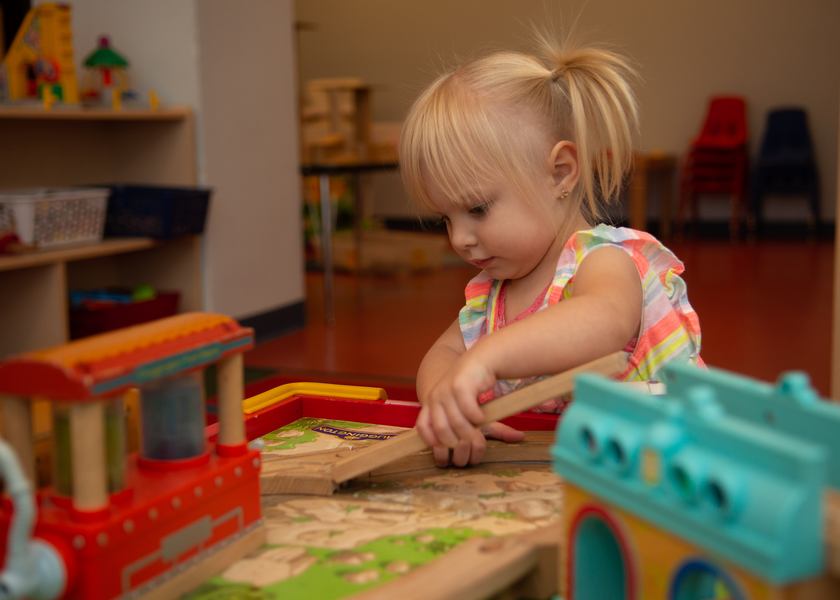  Toddler plays withntrain set