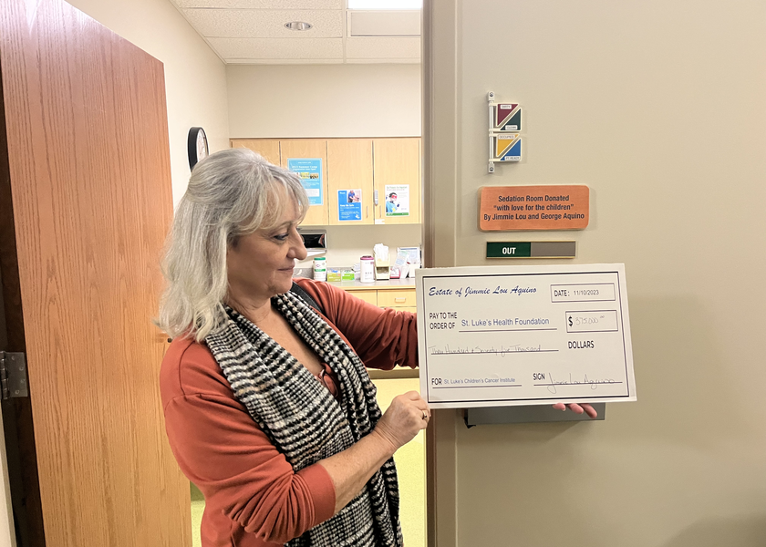 Woman holding an enlarged check