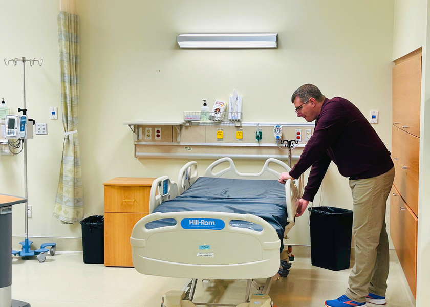  Man working on a hospital bed