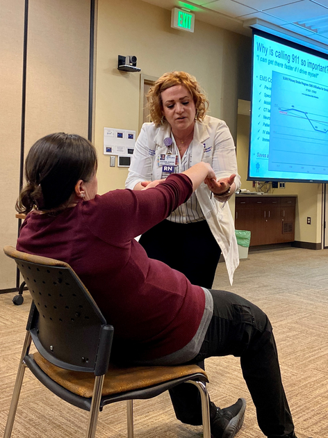 Nurse caring for woman in a chair