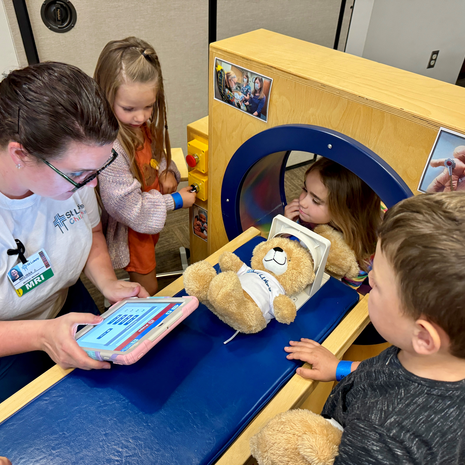 Nurse conducts a teddy bear clinic with kid helpers