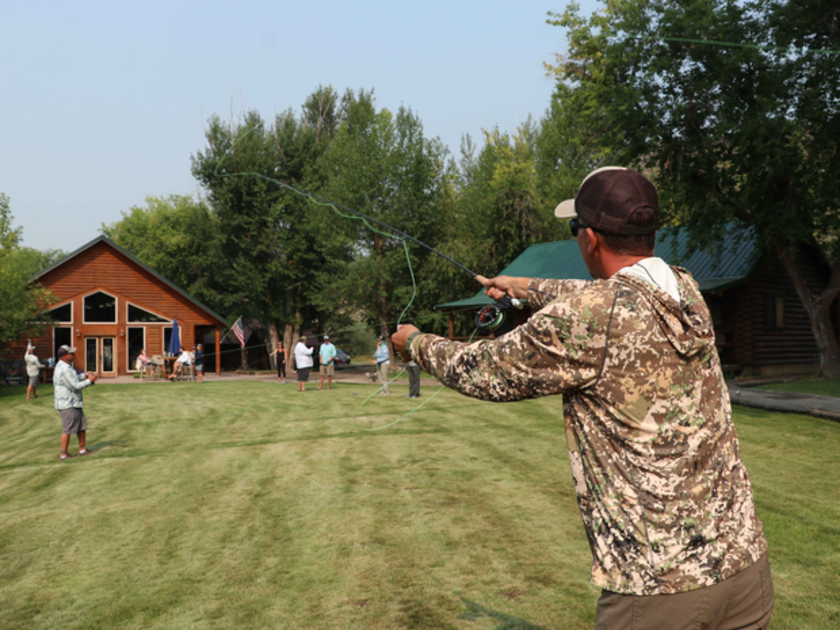 People affected by cancer practicing their fly fishing casts on the lawn.