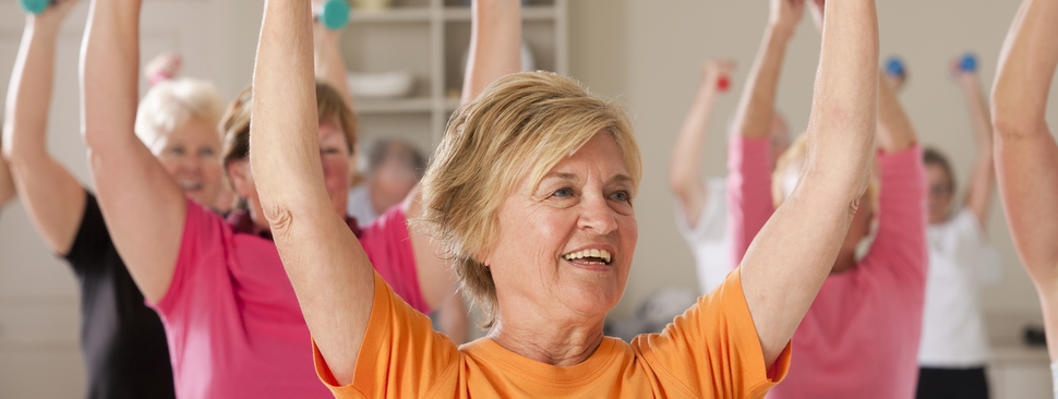 Women lifting weights in a class