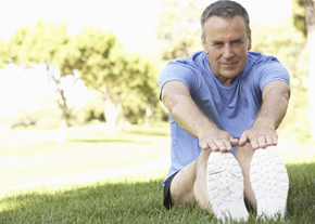A man reaches to touch his toes