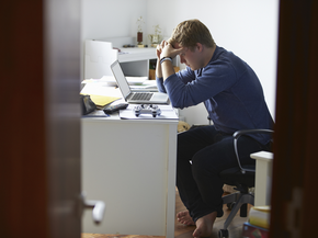 Teenager in distress at his desk
