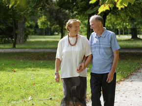 Couple walking through park