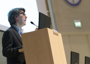 A speaker talks while standing at a podium