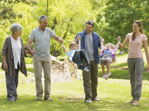 Grandparents, kids and grandkids walking in park