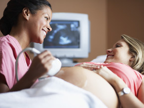Pregnant lady receiving ultrasound from nurse