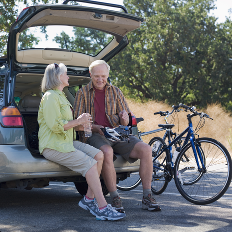 Older couple sitting on tailgate