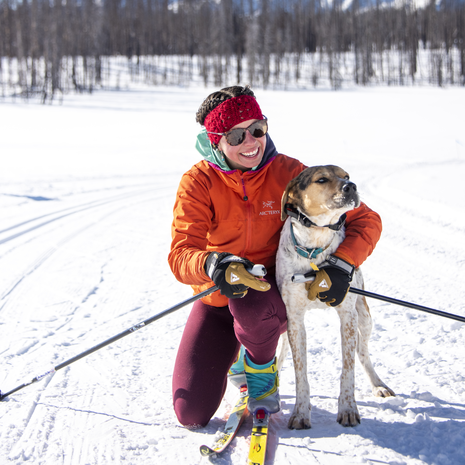Woman and her dog cross country skiiing