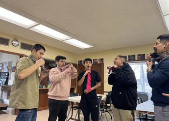 Young men tying ties