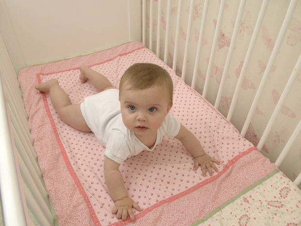 A baby girl in her crib.