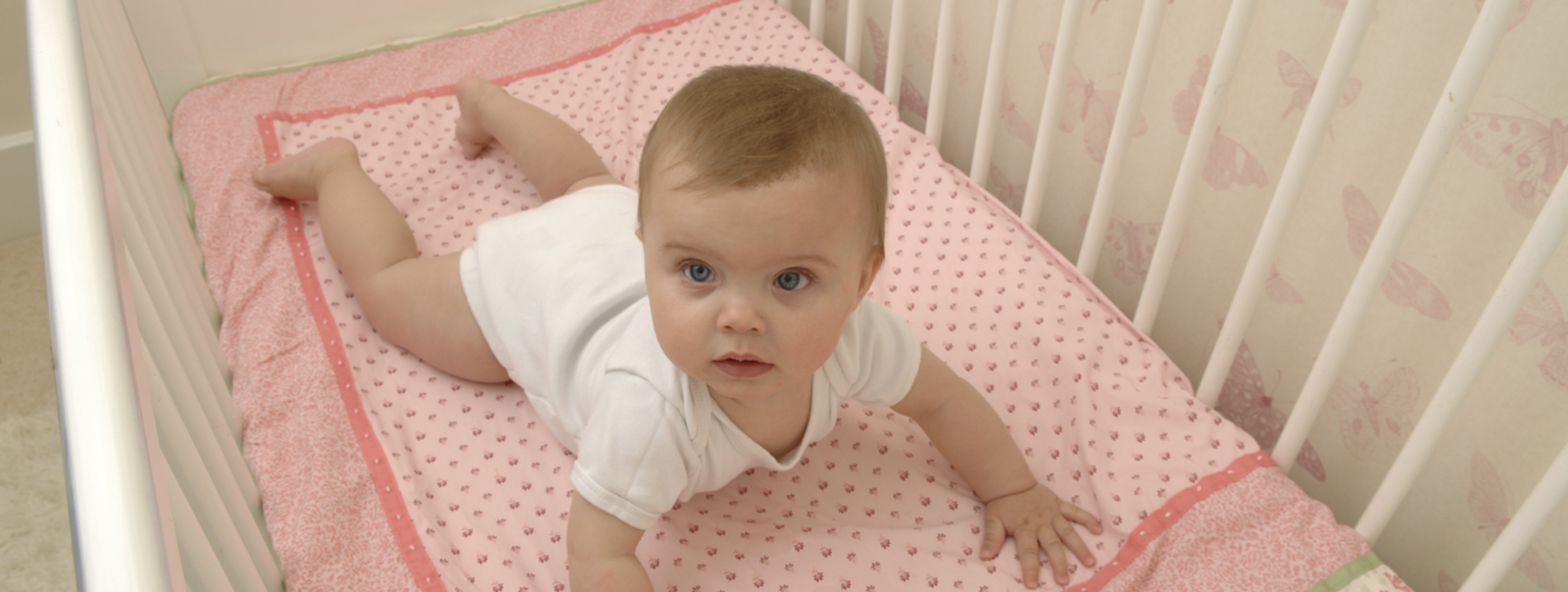 A baby girl in her crib.