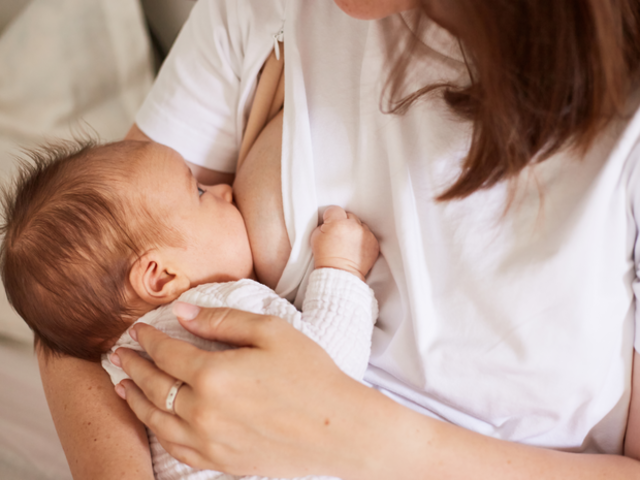 Baby feeding at mother’s breast.