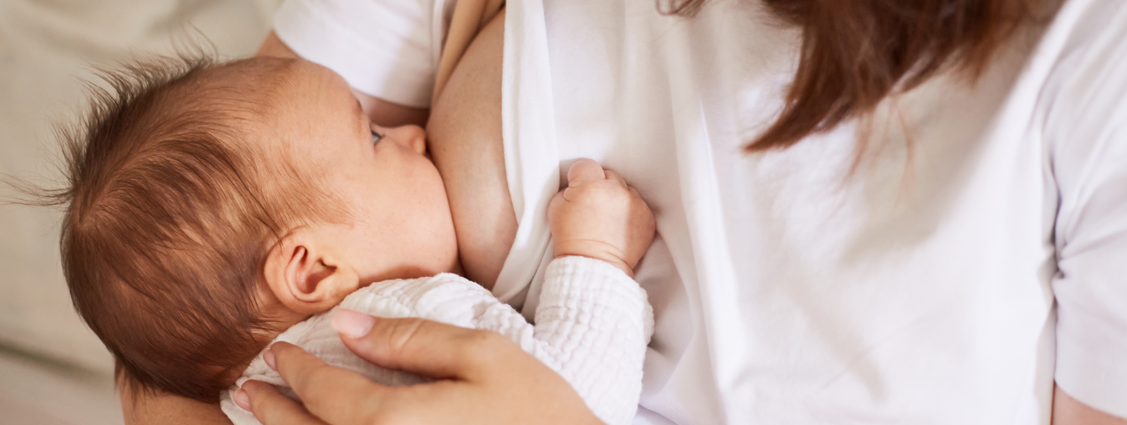 Baby feeding at mother's breast.