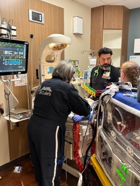 Geoff Carr working as an RT in a patient room.