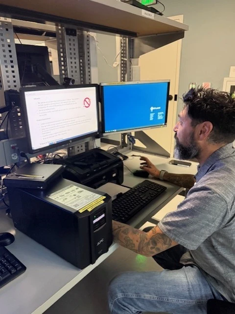 Geoff Carr at a desk working on a computer.