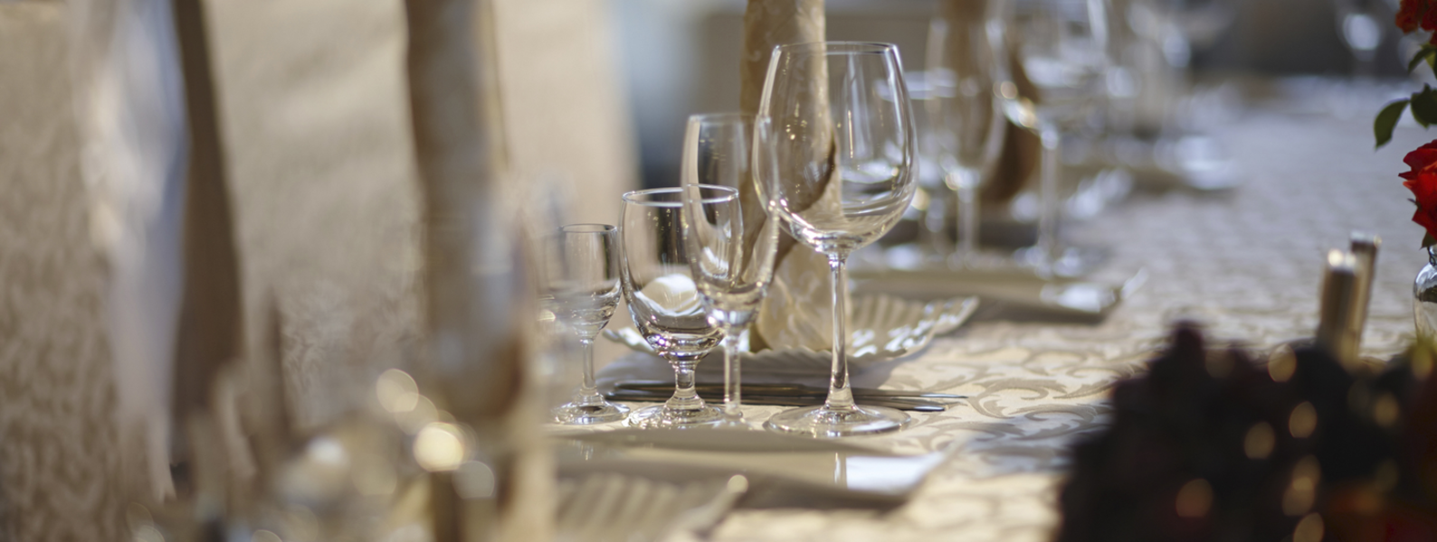 A table set with cloth and glasses