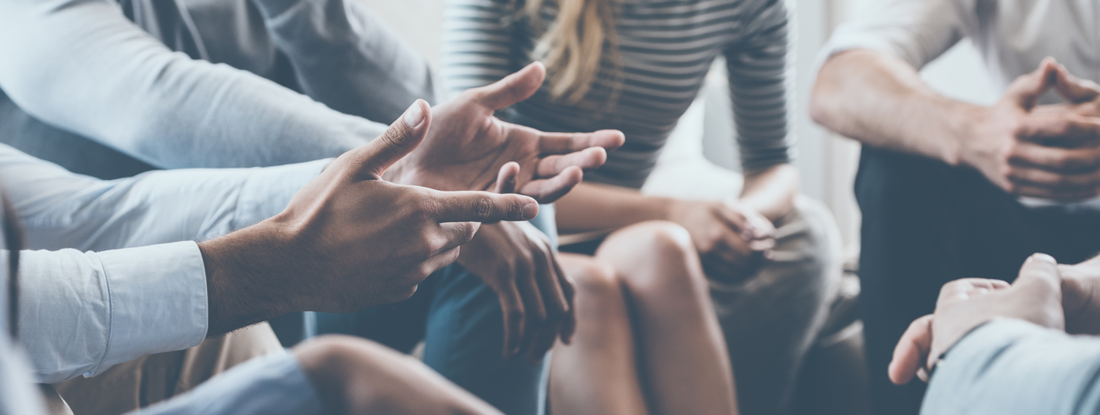 A group of people speaking in a circle.