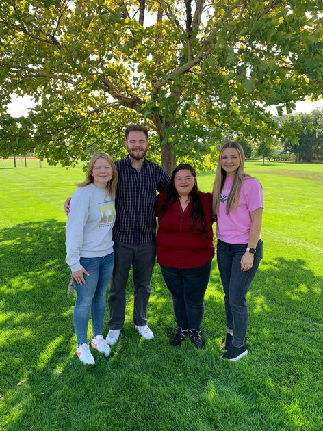  Young adults standing under tree