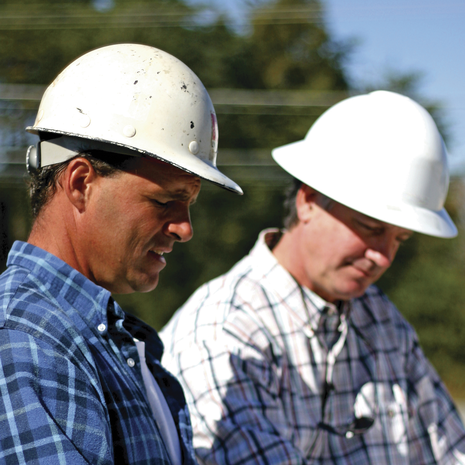Two men wearing hard hats