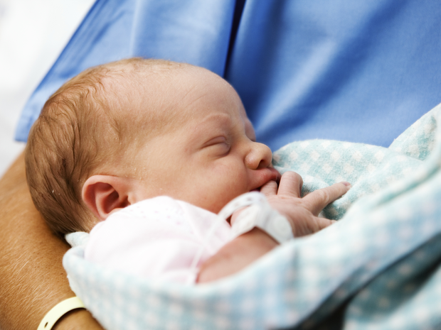 Baby being held by nurse