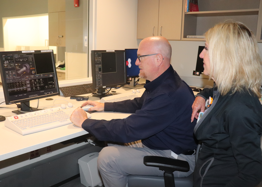 Two people looking at computer monitor