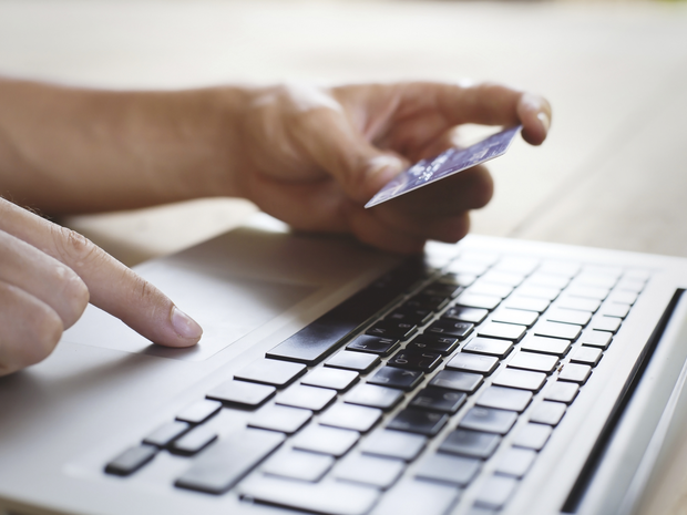 Person paying bill online with credit card.