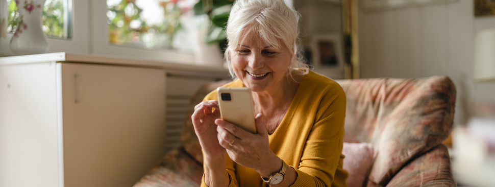 Woman smiling at her phone