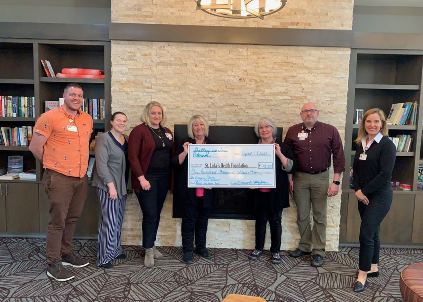 Group of people pose with a large donor check from Imogene.