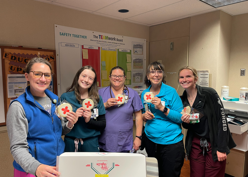 Boise team members holding cookies celebrating efforts towards goal of zero preventable harm..
