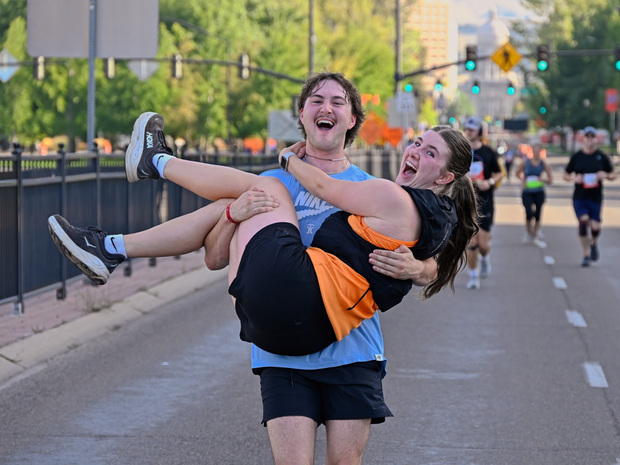 Man carrying woman on the FitOne race course