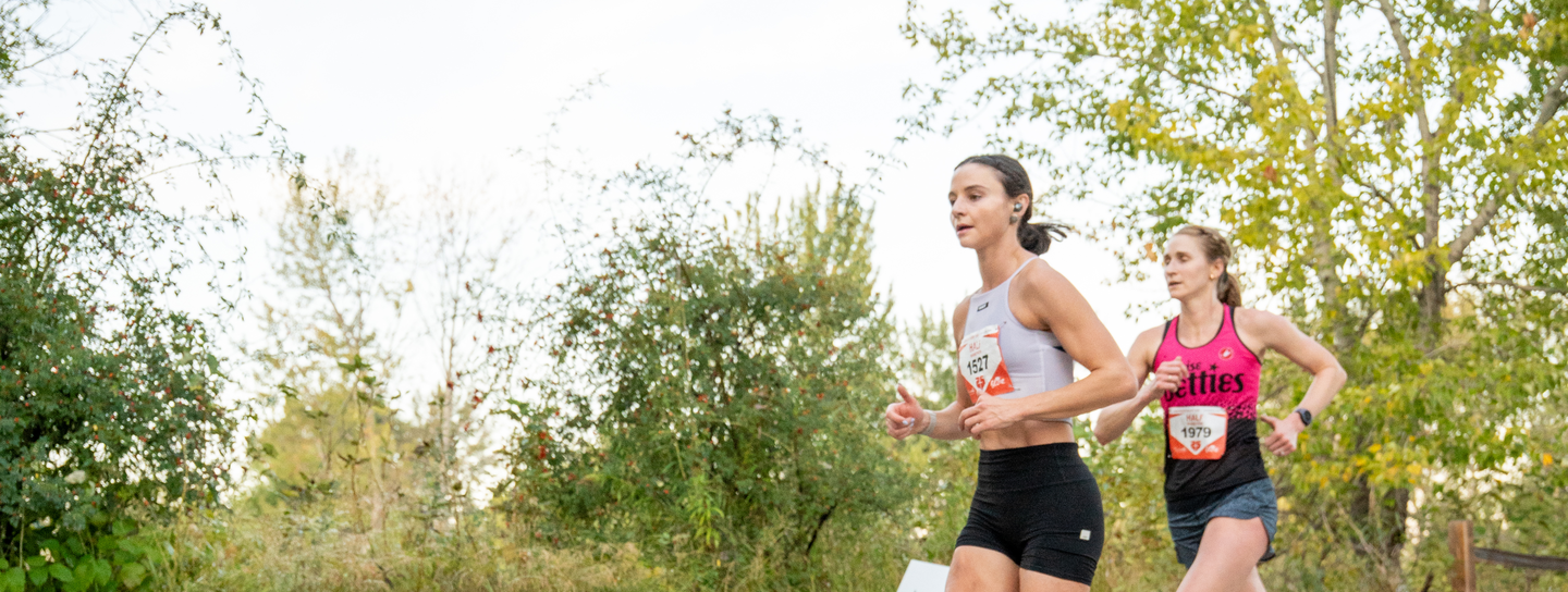 group of women smiling and running FitOne together