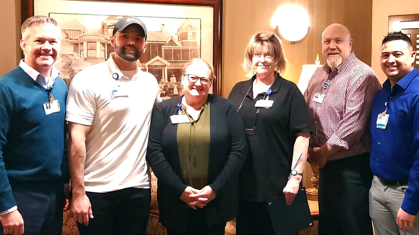  Deb poses with St. Luke's team members, including CEO Chris Roth.