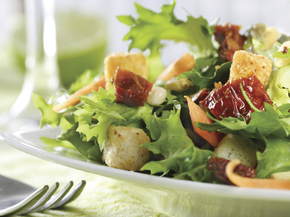 A bowl of salad on a table.