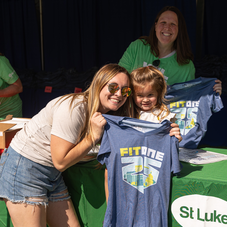 Mom and daughter showing off race shirt