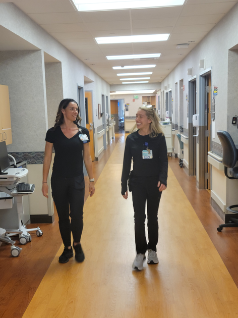  Two women walking down a hall