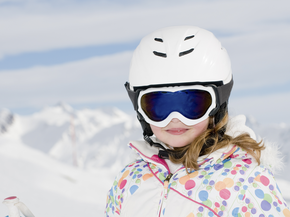 Young snowboarder wearing helmet enjoying the outdoors