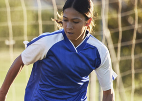 A girl plays soccer