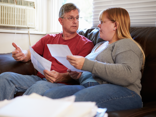 Couple on couch going over bills