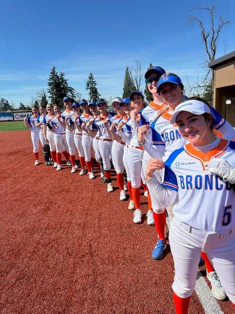 Softball players outside the dugout at Boise State.