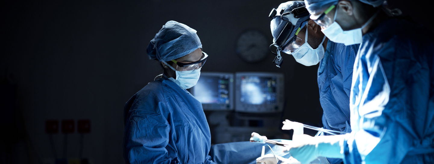 Team of surgeons performing a surgery in an operating room