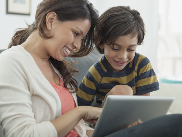 A teacher and student work on a tablet computer