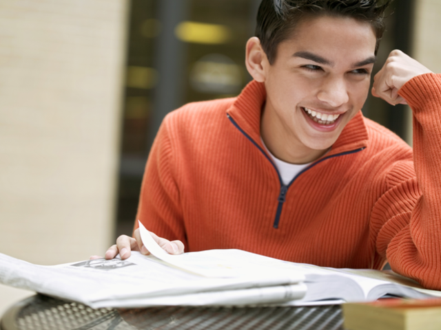 Teen boy reading book