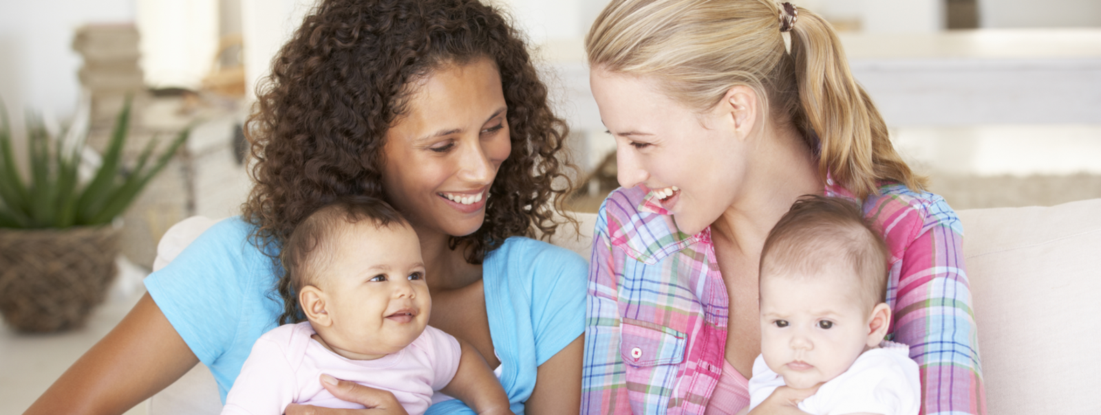 Two moms holding their babies.