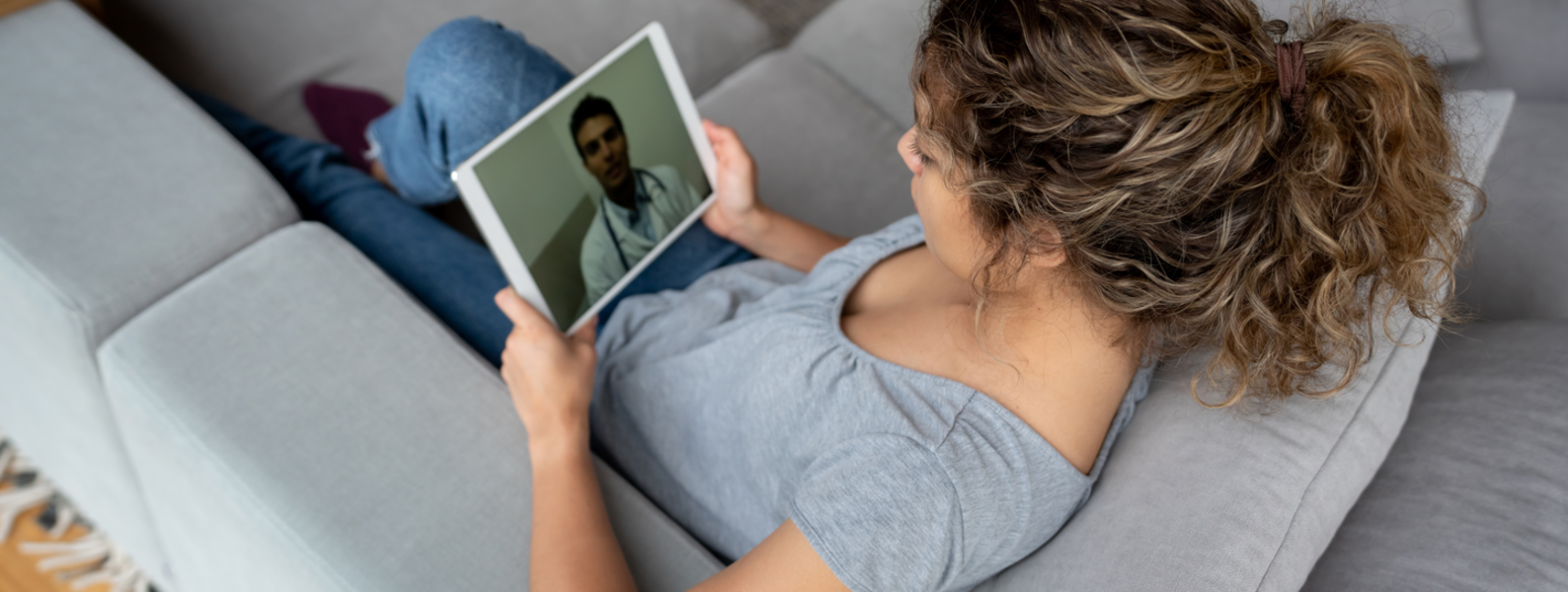 Woman using a tablet for a virtual health care appointment.